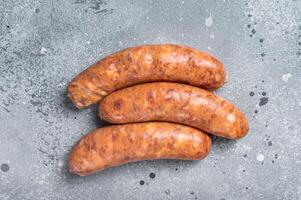 Raw Chorizo sausages for BBQ with spices. Gray background. Top view. Copy space photo