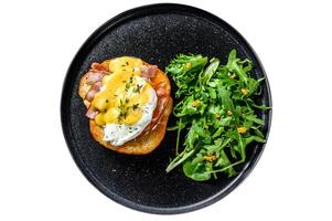 Breakfast Burger with bacon, egg Benedict, hollandaise sauce on brioche bun. Isolated on white background. photo