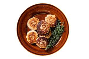 Fried pork and beef meat cutlets or patty in a rustic plate. Isolated, white background. Top view. photo