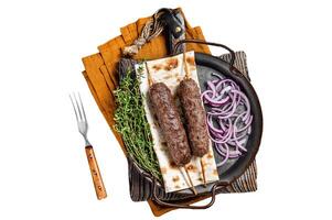 Turkish Adana Kebab from mince lamb beef meat on Skewer with flatbread and onion. Isolated, white background. photo