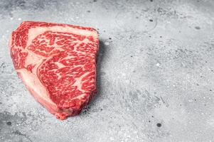 Japanese wagyu rib eye beef meat steak. Gray background. Top view. Copy space photo