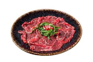 Carpaccio marbled beef meat with arugula and pomegranate seeds. Isolated on white background, top view. photo