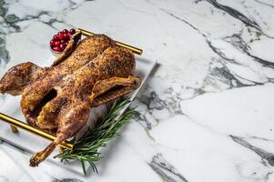 Roasted duck stuffed with baked apples, festive christmas recipe. Marble background. Top view. Copy space photo