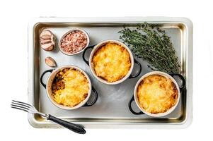 Irish Shepherd's pie with mince meat, mashed potato and cheddar cheese crust. Isolated on white background, top view. photo