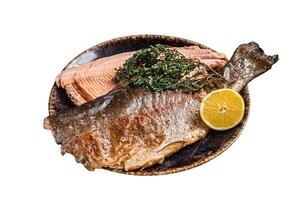 Trout roasted fillet, grilled fish on a plate with thyme and lemon. Isolated on white background. Top view. photo