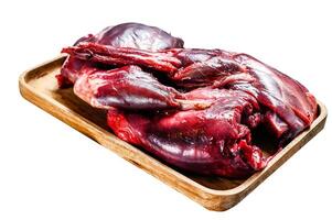 Hare meat. Raw fresh wild hare on a wooden table Isolated on white background. Top view. photo