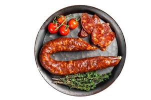 Sliced Chorizo sausage, slices of dry cured pork with herbs and spices. Isolated on white background. photo