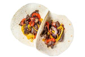 Fajitas with beef meat stripes, colored bell pepper and onions, served with tortillas and salsa. Isolated on white background. photo
