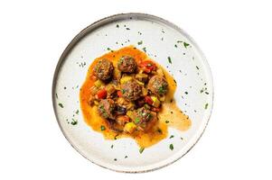 Delicious meatballs made from ground beef in tomato sauce, served in old metal pan. Isolated on white background. photo