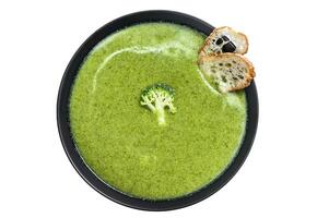 Homemade Broccoli soup with fresh baguette. Isolated on white background. photo