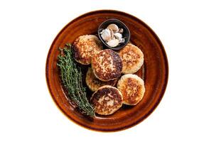 Fried pork and beef meat cutlets or patty in a rustic plate. Isolated, white background. Top view. photo