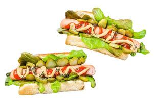 Homemade hot dogs with vegetables, lettuce and condiments. Isolated on white background. Top view. photo