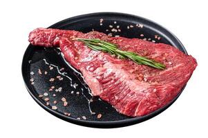 Seasoned raw tri-tip beef meat steak on plate. Isolated on white background. Top view. photo