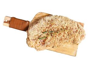Raw chicken schnitzel in breadcrumbs. Isolated on white background. Top view. photo