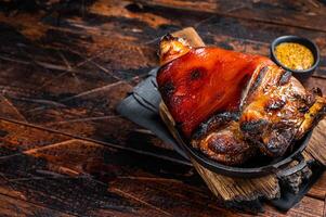 Bavarian Schweinshaxe Roast pork Hock Ham, knuckle with Sauerkraut. Wooden background. Top view. Copy space photo