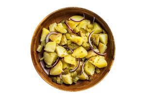Bowl of warm potato salad with bacon, German Kartoffelsalat. Isolated on white background. photo