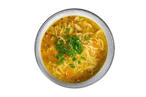 Fresh homemade chicken soup with noodle at table. Isolated, white background. Top view. photo