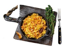 Stewed cabbage Bigos with mushrooms and sausages. Isolated on white background, Top view. photo