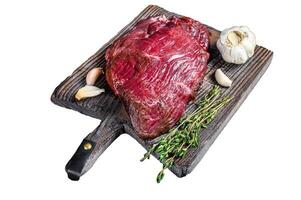 Venison raw deer meat on a cuuting board with herbs. Isolated on white background, Top view. photo