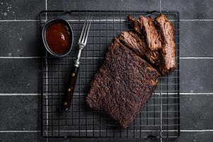 Chopped Beef Brisket barbecue, Traditional meat rubbed with spices and smoked in a Texas smoker. Black background. Top view photo