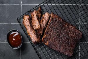 Chopped Beef Brisket barbecue, Traditional meat rubbed with spices and smoked in a Texas smoker. Black background. Top view photo
