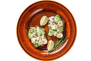 Scandinavian Sandwiches with shrimp, prawns, quail eggs and cucumber on rye bread. Isolated on white background. photo