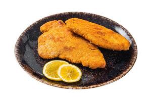 Roasted breaded german weiner schnitzel on a plate. Isolated on white background. Top view. photo