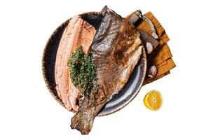 Trout roasted fillet, grilled fish on a plate with thyme and lemon. Isolated, white background. photo