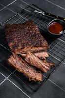 Chopped Beef Brisket barbecue, Traditional meat rubbed with spices and smoked in a Texas smoker. Black background. Top view photo