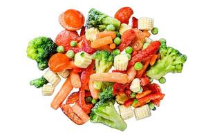 Frozen cold sliced Vegetables, broccoli, sweet peppers, tomatoes, carrots, peas and corn. Isolated on white background, Top view. photo