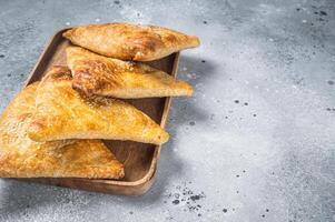 Samosa, samsa meat stuffed oriental pies. Gray background. Top view. Copy space photo
