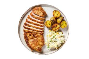Homemade breaded german weiner schnitzel with potatoes and salad. Isolated on white background. photo