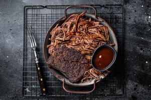 Slow Cooked Pulled Beef, Traditional meat rubbed with spices and smoked in a Texas smoker. Black background. Top view photo