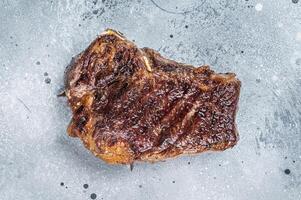 Grilled Striploin beef meat steak or new york steak. Gray background. Top view. Copy space photo