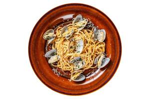 Italian seafood Spaghetti pasta with clams in a rustic plate. Isolated, white background. Top view. photo