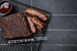 Chopped Beef Brisket barbecue, Traditional meat rubbed with spices and smoked in a Texas smoker. Black background. Top view. Copy space photo