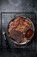 Slow Cooked Pulled Beef, Traditional meat rubbed with spices and smoked in a Texas smoker. Black background. Top view photo