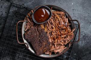 Slow Cooked Pulled Beef, Traditional meat rubbed with spices and smoked in a Texas smoker. Black background. Top view photo