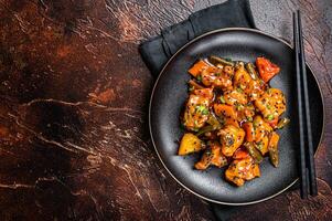 Chinese cuisine sweet and sour pork guo bao rou. Dark background. Top view. Copy space photo