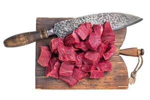 Diced Raw Venison meat, fresh Wild Roe Deer Game Meat on butcher cutting board Isolated on white background. top view photo