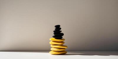 A stack of yellow and black rocks with a separate pile of black rocks on top. photo