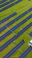 Drone flight over solar panels field. Aerial drone point view of powerful station with solar panels generates electric current. Vertical video