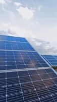 Sunny batteries on the field. Innovative equipment in electricity. Alternative green energy from solar panels. Sunny energy production plant. Vertical video