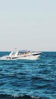 Small cruise ship with passengers. Small ferry with passengers crossing sea. Vertical video