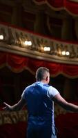 Rehearsal before the performance. Actor man is talking to the empty auditorium during pandemic in the world. Speaker talking in the theater with no people. Vertical video