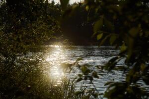 Experience the Serene Water Reflection at Sunset, Surrounded by Beautiful Nature and Serenity photo