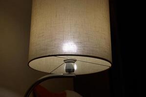 This elegant table lamp produces a soft glow, creating a cozy and inviting ambiance photo