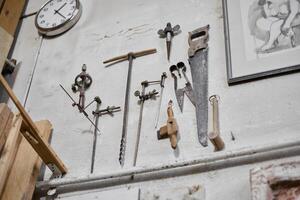 A beautiful collection of vintage workshop tools artfully arranged and displayed on a wall photo