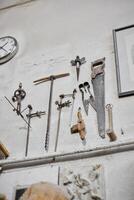 A Beautiful Collection of Vintage Tools Elegantly Hanging on a Workshop Wall for Display photo