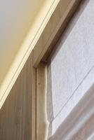 An Elegant Wooden Trim Featuring Soft Fabric Blinds for a Chic and Inviting Ambiance photo